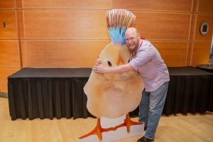 TCG President Daniel Turner hugging a 6-foot chick.